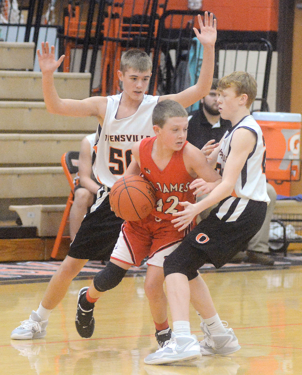 Bryce Kramme (eft) and Kylen Menz (right) trap a St. James ball handler during last Wednesday’s daytime middle school boys basketball doubleheader between the host Owensville Dutchmen and visiting St. James Tigers.